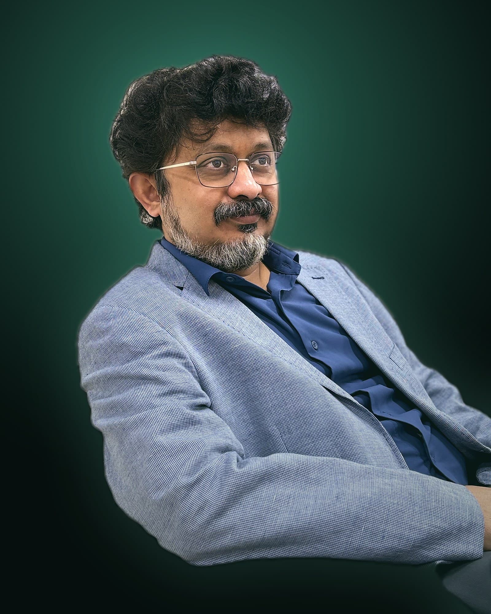 Dr. Amol Gawande seated, looking thoughtfully to the side